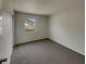 Bedroom with gray carpet, light colored walls and a window at 145 Zacalo Way, Kissimmee, FL 34743