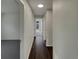 Neutral-toned hallway with luxury vinyl plank flooring, fresh paint, and solar tube lighting at 145 Zacalo Way, Kissimmee, FL 34743