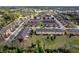 Aerial view of a well-maintained residential community with townhomes, green spaces, and convenient parking at 1558 Downy Birch Ln, Longwood, FL 32750