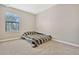 Neutral bedroom with carpet, a window with blinds, and a gray striped comforter at 1558 Downy Birch Ln, Longwood, FL 32750