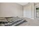 Bedroom with plush carpet, closet with bifold doors, and a gray striped comforter on the floor at 1558 Downy Birch Ln, Longwood, FL 32750