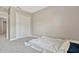 Bedroom with plush carpet, closet with bifold doors, and a white comforter on the floor at 1558 Downy Birch Ln, Longwood, FL 32750