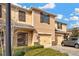 Charming tan townhome with a one-car garage, well-maintained front yard, and inviting entrance at 1558 Downy Birch Ln, Longwood, FL 32750