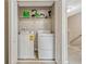 Bright laundry room featuring modern appliances, ample shelving, and neutral-colored walls at 1558 Downy Birch Ln, Longwood, FL 32750