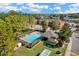 Aerial shot showcases the community pool with lounge chairs and a gazebo for relaxation at 1558 Downy Birch Ln, Longwood, FL 32750