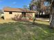 A view of the home's backyard, showcasing a small wooden deck, and a mix of grassy and shaded areas at 1583 Montgomery Ave, Holly Hill, FL 32117