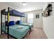 Bedroom with bunk bed, two twin beds and a mounted flat-screen television at 16207 Trinidad Way, Clermont, FL 34714