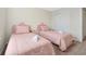 Charming bedroom features two twin beds with pink linens and crown-shaped headboards at 16207 Trinidad Way, Clermont, FL 34714