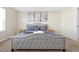 Comfortable bedroom featuring a queen-sized bed with gray bedding and wall art at 16207 Trinidad Way, Clermont, FL 34714