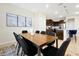 Charming dining area with modern decor that transitions to a sleek kitchen with stainless steel appliances and bar seating at 16207 Trinidad Way, Clermont, FL 34714