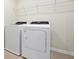 Laundry room with washer, dryer and wire shelving at 16207 Trinidad Way, Clermont, FL 34714