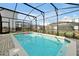 A stunning backyard pool is fully screened and ready for Gathering fun at 16207 Trinidad Way, Clermont, FL 34714