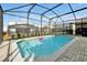 Relaxing in-ground screened pool with patio and nearby houses at 16207 Trinidad Way, Clermont, FL 34714