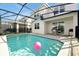 A beautiful screened in pool features patio seating and an exterior barbecue at 16207 Trinidad Way, Clermont, FL 34714