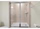 Walk-in shower features tile surround, glass doors and shower head at 16207 Trinidad Way, Clermont, FL 34714