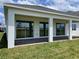 Covered back patio featuring large sliding glass doors and a view of the backyard at 16880 Muskgrass Dr, Winter Garden, FL 34787