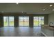Open living space featuring tile floors and large sliding glass doors leading to the backyard at 16880 Muskgrass Dr, Winter Garden, FL 34787