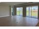 Bright living room featuring sliding glass doors leading to the lanai and tile floors at 16880 Muskgrass Dr, Winter Garden, FL 34787