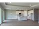 Open-concept living space with wood-look tile flooring, recessed lighting, and a view into the modern kitchen at 16880 Muskgrass Dr, Winter Garden, FL 34787