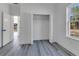 Bedroom featuring light gray flooring, white walls, closet, and a window view of the outdoors at 17825 Sw 34Th Ter, Ocala, FL 34473