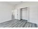 Bright bedroom featuring gray floors, white walls, closet, and a connecting doorway to another room at 17825 Sw 34Th Ter, Ocala, FL 34473