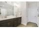 Bathroom featuring a double vanity, quartz countertops, and wood-look tile flooring at 17858 Adrift Rd, Winter Garden, FL 34787