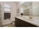 Bathroom featuring double sink vanity, quartz countertops, and wood-look tile flooring at 17858 Adrift Rd, Winter Garden, FL 34787