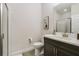 Bathroom featuring a toilet next to the sink and a glass-walled shower at 17858 Adrift Rd, Winter Garden, FL 34787