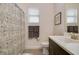 Bathroom featuring a shower and a dark vanity with light quartz countertops at 17858 Adrift Rd, Winter Garden, FL 34787