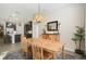 Stylish dining area open to kitchen, featuring modern light fixture and wooden furniture at 17858 Adrift Rd, Winter Garden, FL 34787