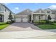 Charming home featuring a three-car garage and a brick driveway at 17858 Adrift Rd, Winter Garden, FL 34787