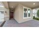 A welcoming front entrance with a brick-paved walkway and covered porch at 17858 Adrift Rd, Winter Garden, FL 34787