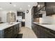 Contemporary kitchen with dark cabinetry, subway tile backsplash, and stainless steel appliances at 17858 Adrift Rd, Winter Garden, FL 34787