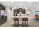 Bright kitchen with an island, stainless steel refrigerator, and a view of the adjacent room at 17858 Adrift Rd, Winter Garden, FL 34787