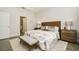 Bright main bedroom showcasing wood-look tile floors, a decorative rug, and ample natural light at 17858 Adrift Rd, Winter Garden, FL 34787