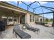 Screened lanai with lounge chairs overlooking the manicured lawn and lush landscaping at 17858 Adrift Rd, Winter Garden, FL 34787