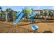 Community playground featuring colorful slides and a rock-climbing area on soft wood chip ground at 17858 Adrift Rd, Winter Garden, FL 34787