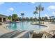 Community pool area with multiple lounge chairs and palm trees creating a relaxing atmosphere at 17858 Adrift Rd, Winter Garden, FL 34787