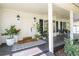 Inviting front porch featuring a stylish door, sleek black shutters and a cozy seating area at 181 N Phelps Ave, Winter Park, FL 32789