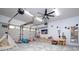 Finished garage space as a playroom, featuring geometric flooring, overhead garage door, and a mounted tv at 181 N Phelps Ave, Winter Park, FL 32789