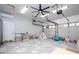 Open garage space converted to playroom featuring faux brick wall, light flooring and overhead garage door at 181 N Phelps Ave, Winter Park, FL 32789