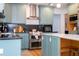 Close up of kitchen features including stainless steel appliances and custom blue cabinets at 181 N Phelps Ave, Winter Park, FL 32789