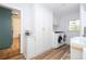 Well-organized laundry room featuring white cabinetry and modern appliances at 181 N Phelps Ave, Winter Park, FL 32789