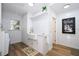 Clean laundry room featuring farmhouse sink, modern washer and dryer, and storage at 181 N Phelps Ave, Winter Park, FL 32789