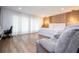 Well-lit main bedroom with wood floors, a large window, a desk, and a comfortable armchair at 181 N Phelps Ave, Winter Park, FL 32789