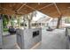 Outdoor kitchen featuring a ceiling fan, built-in grill, countertop seating, and a pool at 181 N Phelps Ave, Winter Park, FL 32789