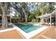 Backyard pool area with cabana, dining table, and lush greenery at 181 N Phelps Ave, Winter Park, FL 32789