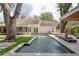 Backyard pool area and covered dining area with lush greenery at 181 N Phelps Ave, Winter Park, FL 32789