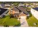 Aerial view of a home showcasing the roof, lawn, landscaping, and a long driveway, capturing a sense of space at 1920 Partin Terrace Rd, Kissimmee, FL 34744