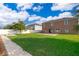 Back yard featuring a grass lawn, pavers and the home's exterior at 1920 Partin Terrace Rd, Kissimmee, FL 34744